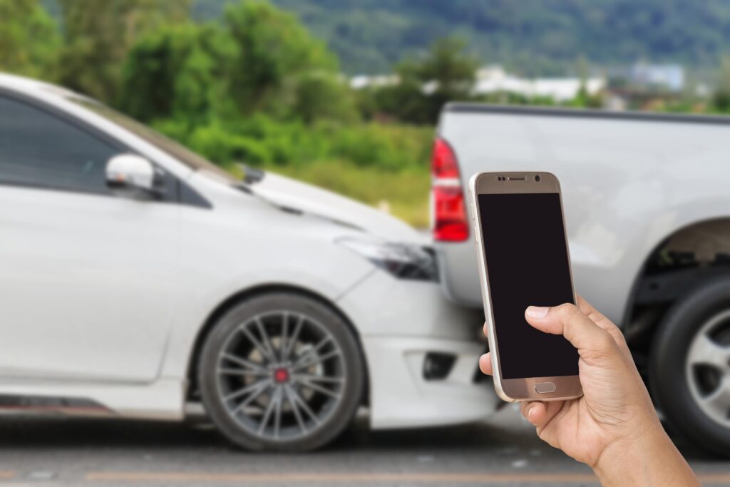 Rear end accident woman holding phone