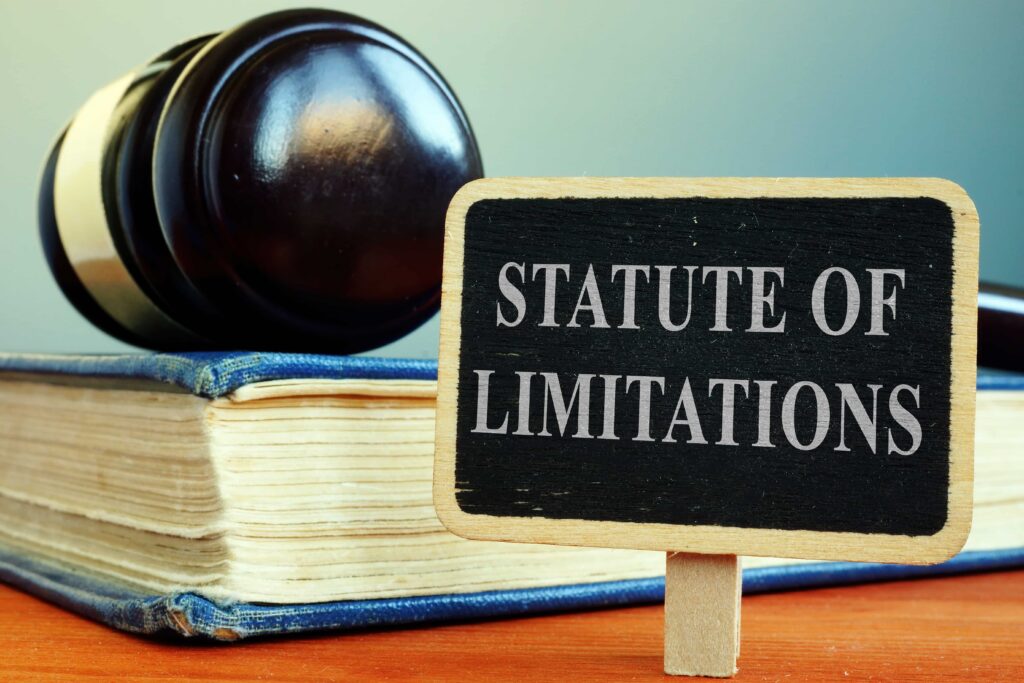 Statute of limitations sign with judge gavel and law book representing legal deadlines for filing claims.