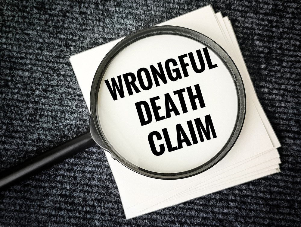 Wrongful Death Claim Concept with Magnifying Glass on Paper, Legal Action, Lawsuit, Justice for Victims, Compensation, Inheritance Rights.