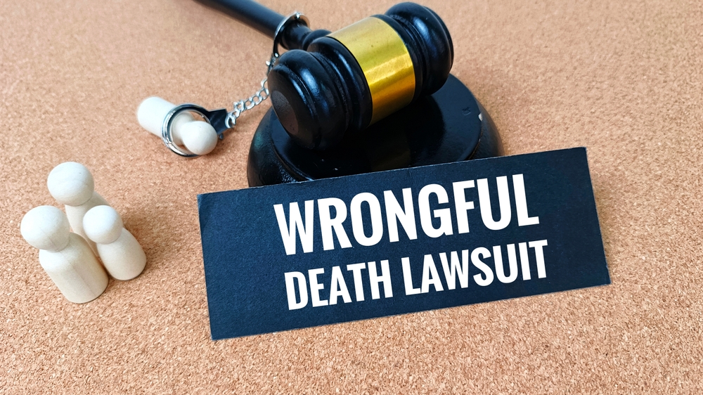 Wrongful Death Laws Concept Judge Gavel with Wooden Figure and Legal Documents Representing Lawsuit, Liability, Compensation, and Justice System.